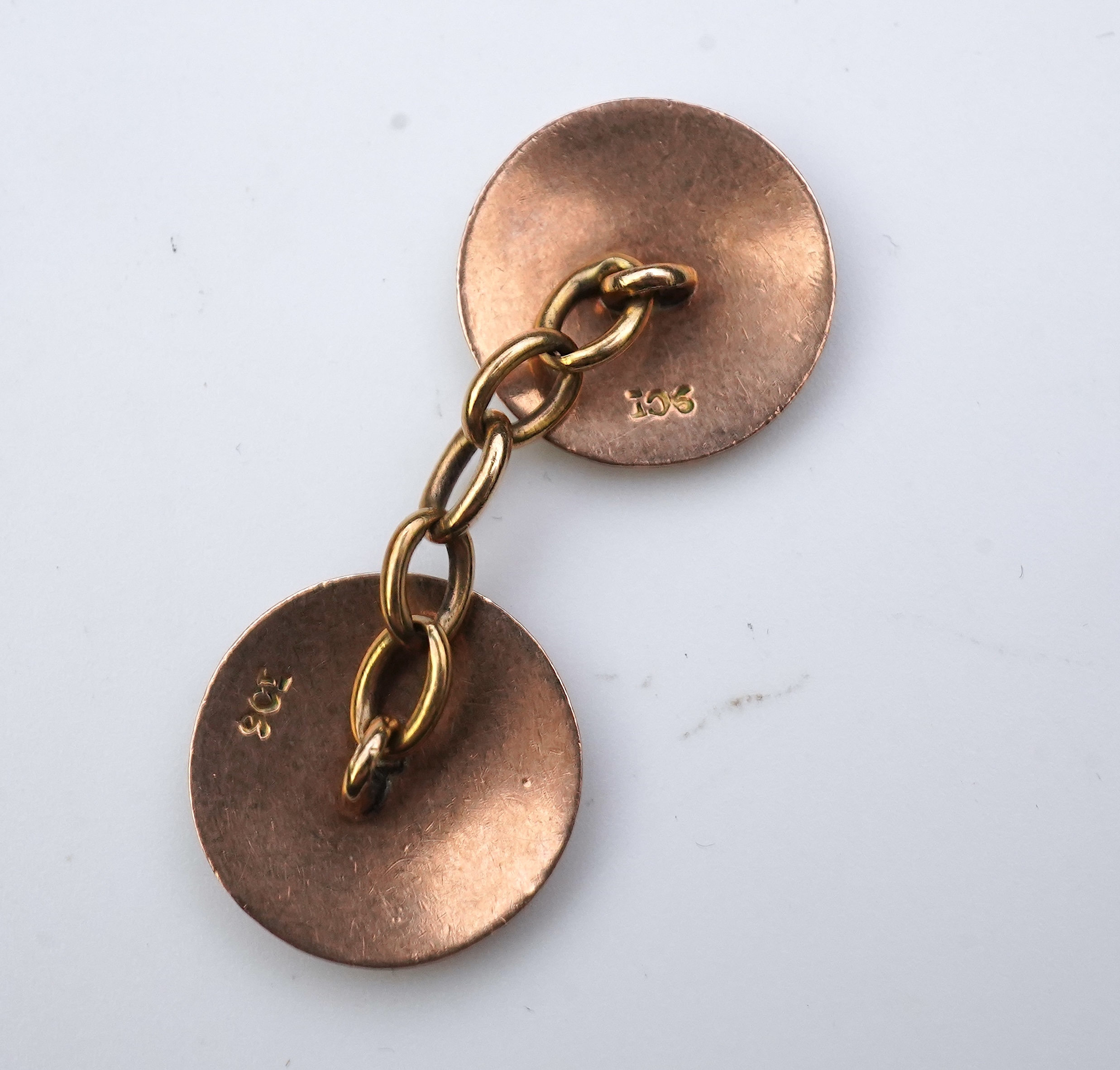 A pair of gold and enamel cufflinks